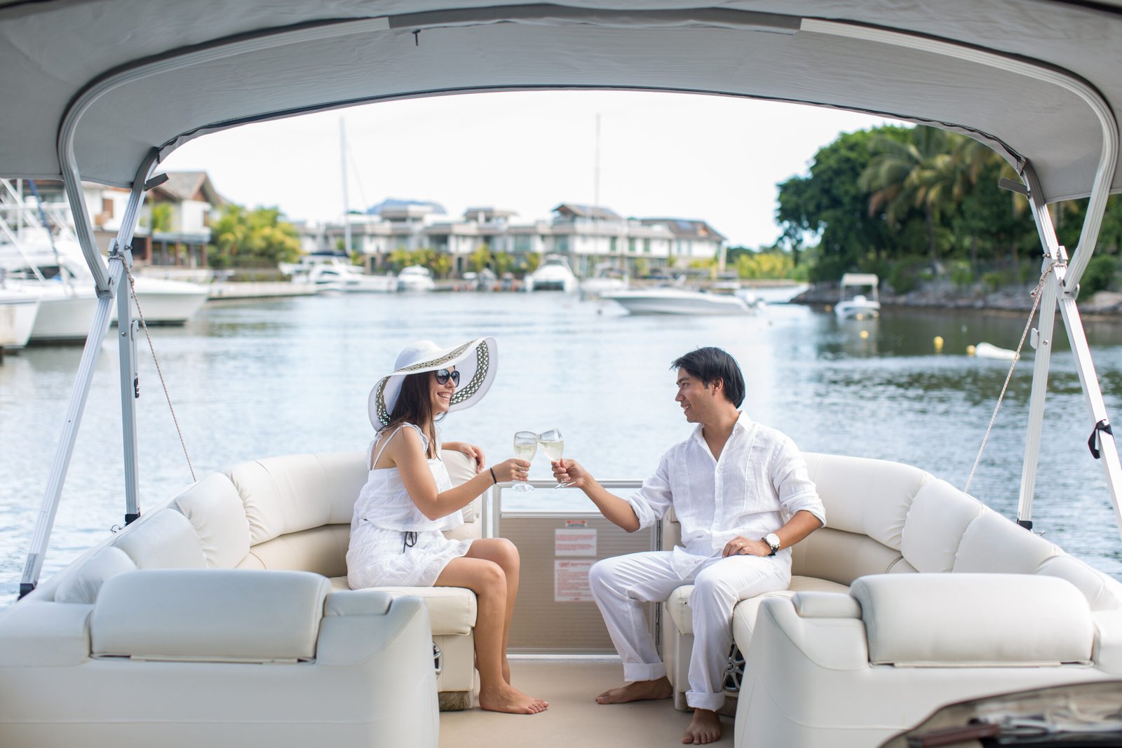 Smiling young couple holding glasses with champagne and looking